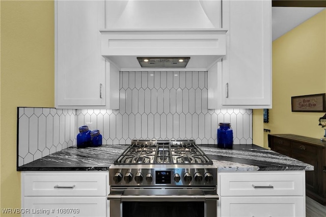 9100 Kirkwood Rd, Fort Smith, AR 72916 - kitchen with premium range hood, dark stone counters, high end stainless steel range oven, decorative backsplash, and white cabinets