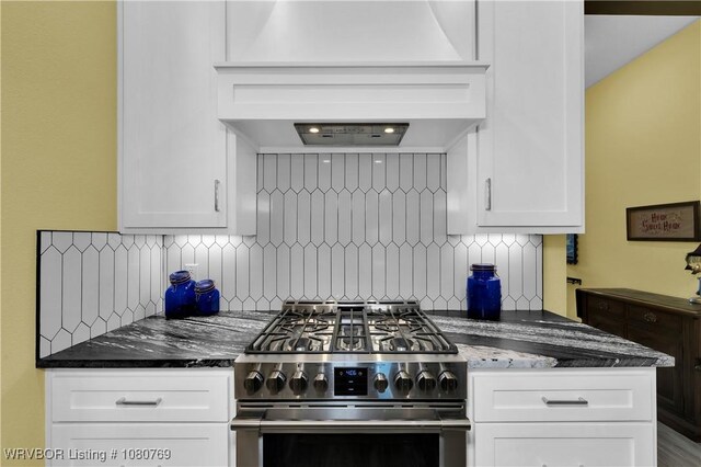 9100 Kirkwood Rd, Fort Smith, AR 72916 - kitchen with stainless steel gas range, premium range hood, tasteful backsplash, white cabinets, and dark stone counters
