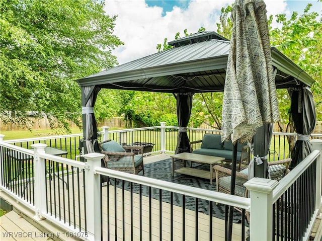 wooden deck featuring a gazebo, an outdoor hangout area, and fence