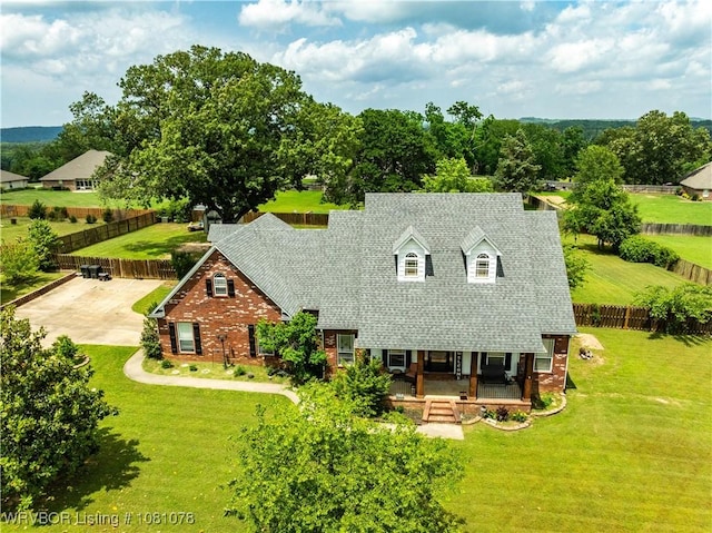 view of front facade featuring brick siding and a porch