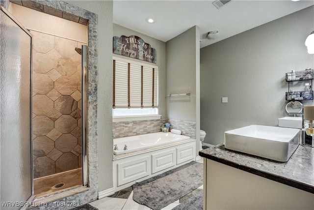 bathroom with a stall shower, a bath, toilet, and tile patterned floors