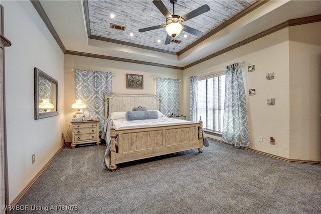 carpeted bedroom with ornamental molding, a raised ceiling, baseboards, and a ceiling fan