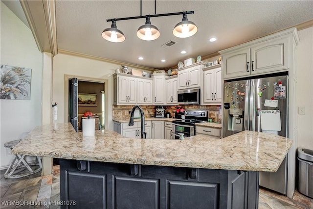kitchen with stainless steel appliances, tasteful backsplash, a breakfast bar area, a spacious island, and light stone counters