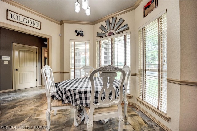 dining area featuring plenty of natural light, ornamental molding, and stone finish floors