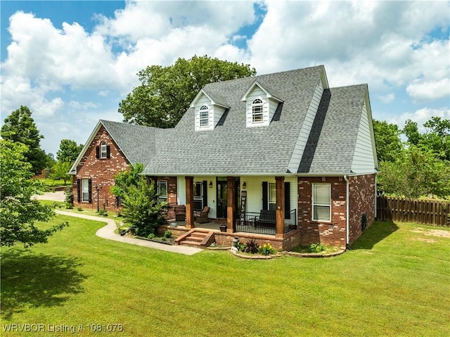 cape cod house featuring a porch, roof with shingles, and brick siding