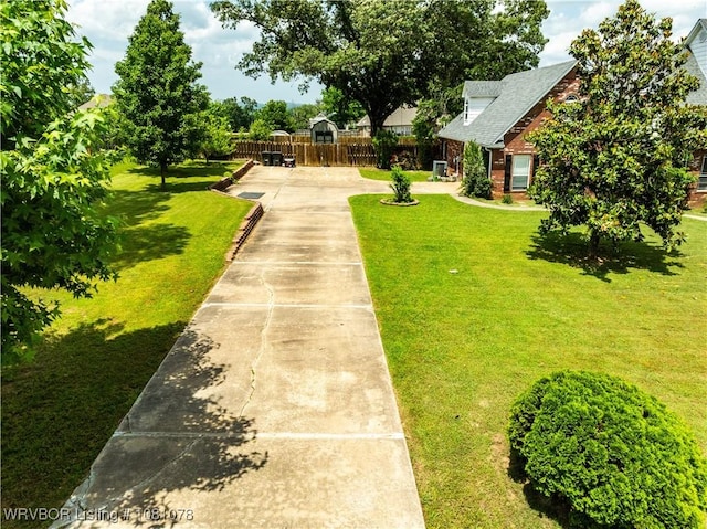 view of home's community with concrete driveway