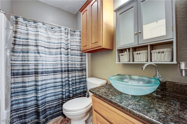 bathroom with vanity, a textured ceiling, toilet, a textured wall, and a shower with curtain