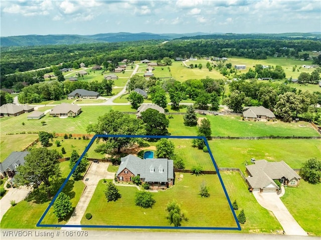 aerial view of residential area featuring property parcel outlined and a mountain backdrop