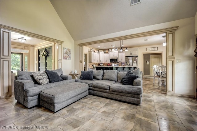 living room featuring high vaulted ceiling