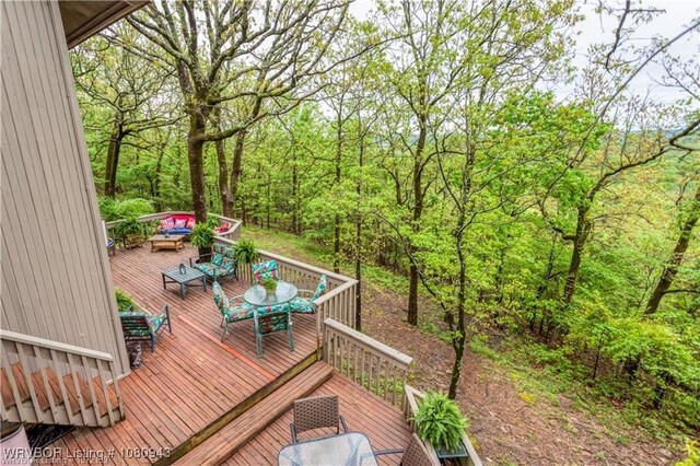 10301 Stoneleige St, Fort Smith, AR 72908 - wooden deck with outdoor dining space and a forest view