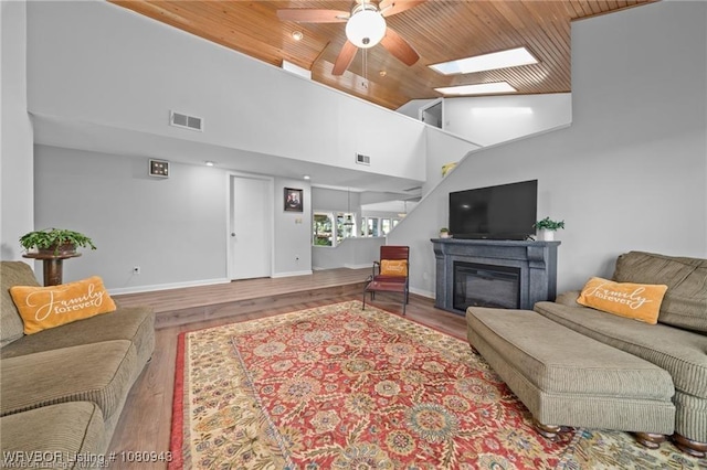 10301 Stoneleige St, Fort Smith, AR 72908 - living room with wooden ceiling, ceiling fan, a skylight, wood finished floors, and baseboards