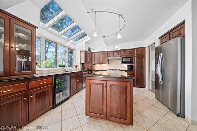 10301 Stoneleige St, Fort Smith, AR 72908 - kitchen with appliances with stainless steel finishes, wine cooler, a skylight, a sink, and tasteful backsplash