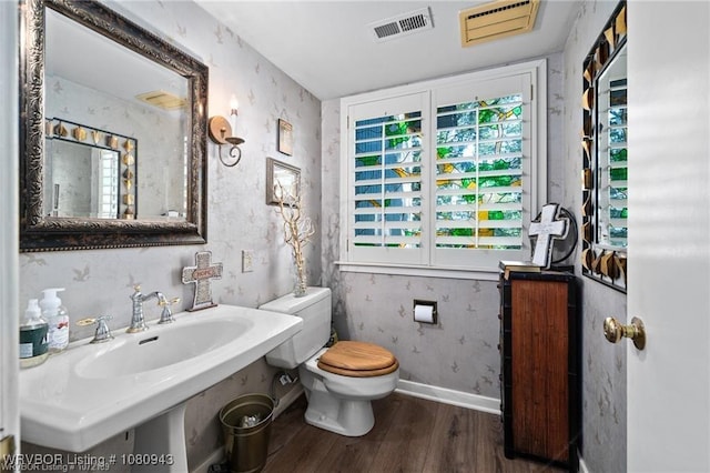 10301 Stoneleige St, Fort Smith, AR 72908 - half bathroom with wood finished floors, a sink, wallpapered walls, toilet, and baseboards