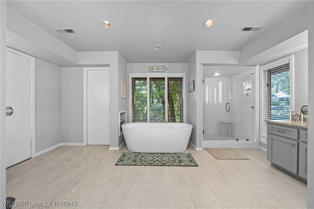 10301 Stoneleige St, Fort Smith, AR 72908 - bathroom featuring a stall shower, recessed lighting, a freestanding tub, vanity, and baseboards