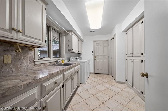 10301 Stoneleige St, Fort Smith, AR 72908 - laundry room with cabinet space, washer and clothes dryer, and light tile patterned flooring