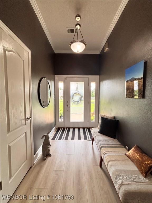 2420 Keystone Cir, Mulberry, AR 73947 - foyer entrance with wood finished floors, ornamental molding, and a textured ceiling