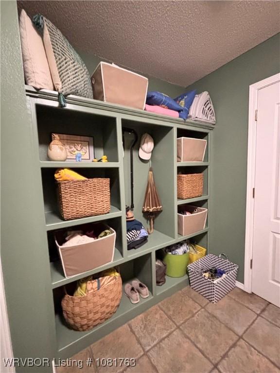 2420 Keystone Cir, Mulberry, AR 73947 - mudroom featuring a textured ceiling