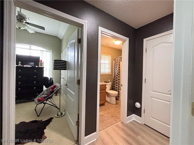 2420 Keystone Cir, Mulberry, AR 73947 - hall with a textured ceiling and light wood-style flooring