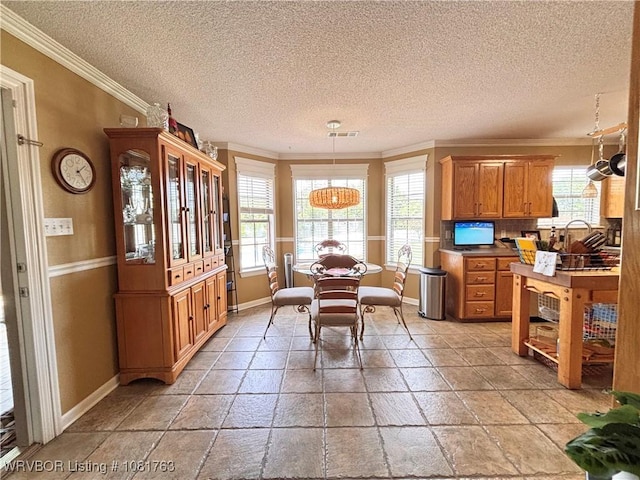 2420 Keystone Cir, Mulberry, AR 73947 - dining space with ornamental molding, a textured ceiling, and stone tile floors