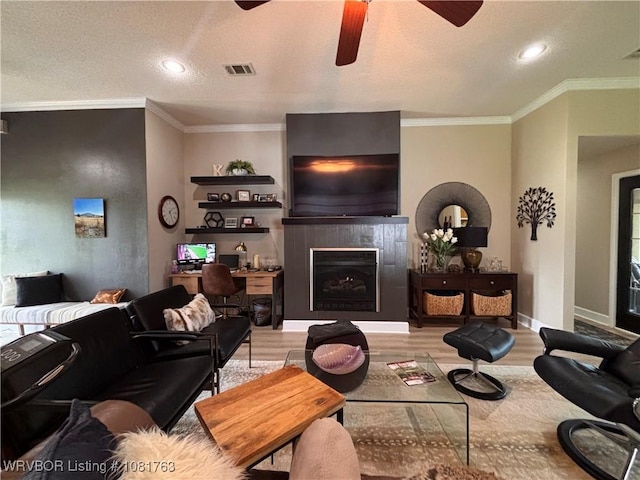 2420 Keystone Cir, Mulberry, AR 73947 - living room with light wood-style flooring, ceiling fan, a fireplace, recessed lighting, and crown molding