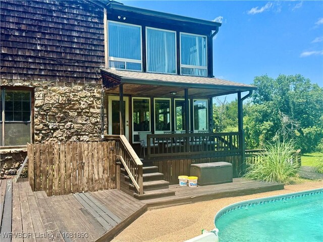 4018 Blue Hole Rd, Rudy, AR 72952 - back of house with a deck, an outdoor pool, and stone siding
