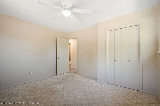 unfurnished bedroom with light carpet, a closet, and ceiling fan