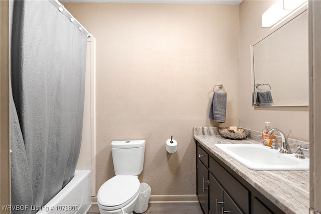 full bathroom with hardwood / wood-style flooring, vanity, shower / tub combo, and toilet