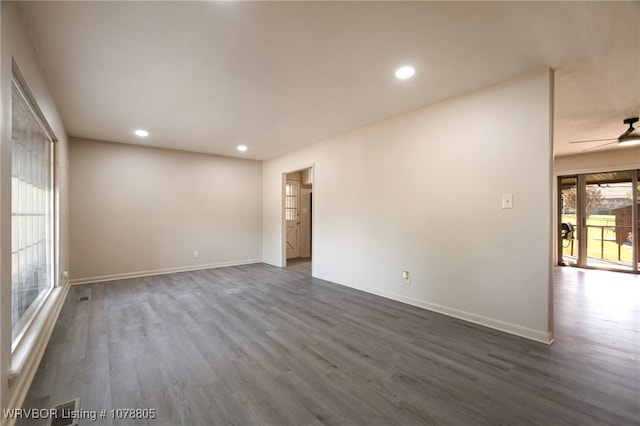 unfurnished room with dark hardwood / wood-style flooring and ceiling fan