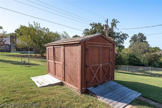 view of outdoor structure featuring a lawn