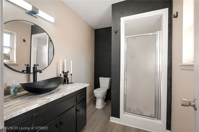 bathroom with vanity, an enclosed shower, wood-type flooring, and toilet