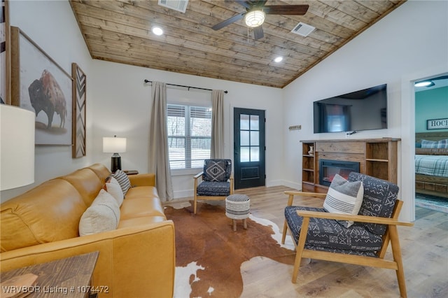 living room featuring hardwood / wood-style flooring, vaulted ceiling, ceiling fan, and wood ceiling