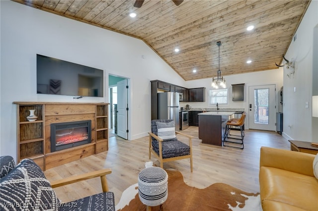 living room with lofted ceiling, light hardwood / wood-style floors, wooden ceiling, and ceiling fan