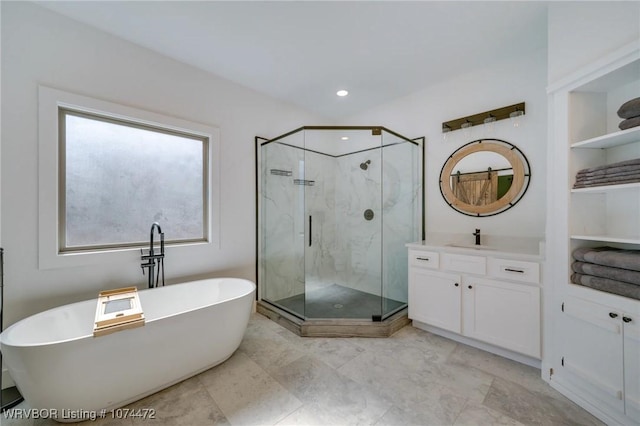 bathroom featuring vanity and independent shower and bath