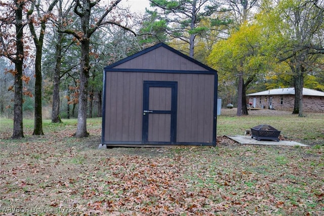 view of outbuilding featuring a fire pit