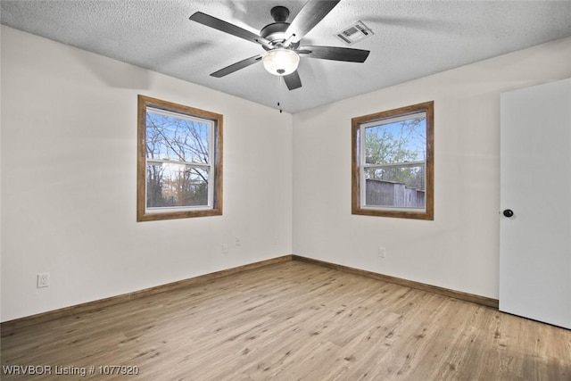 spare room featuring ceiling fan, a textured ceiling, and light hardwood / wood-style flooring