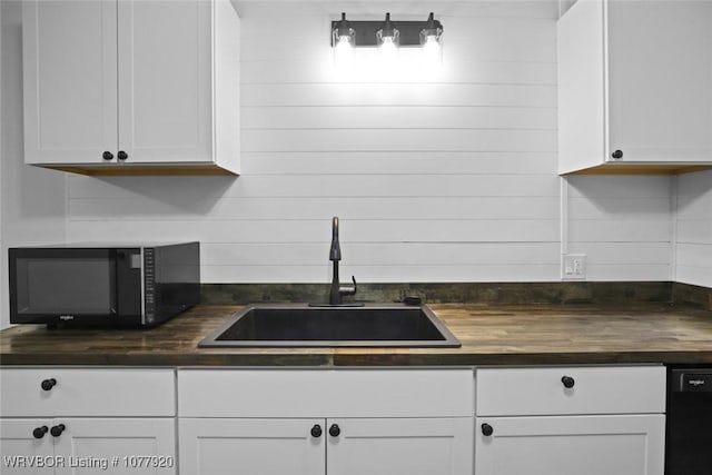 kitchen with sink, white cabinetry, and black appliances