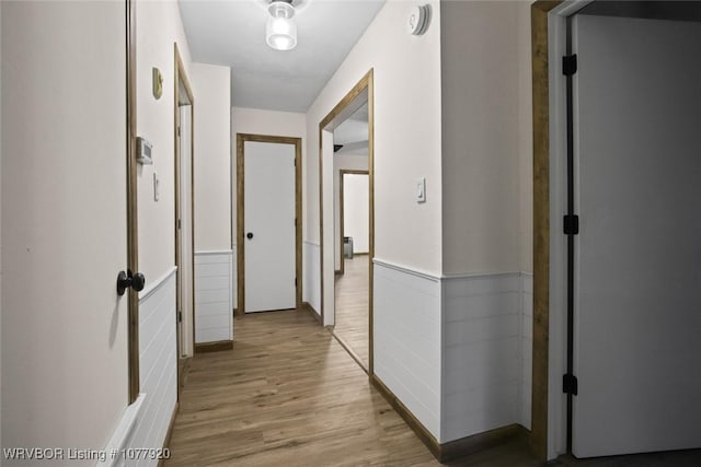 hallway with light hardwood / wood-style flooring