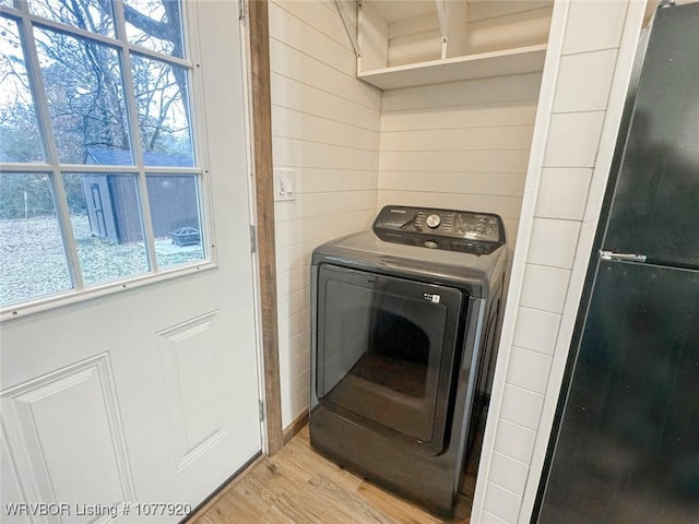 laundry room featuring light hardwood / wood-style flooring, plenty of natural light, and washer / dryer