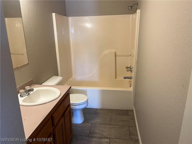 full bathroom featuring vanity, bathtub / shower combination, and toilet