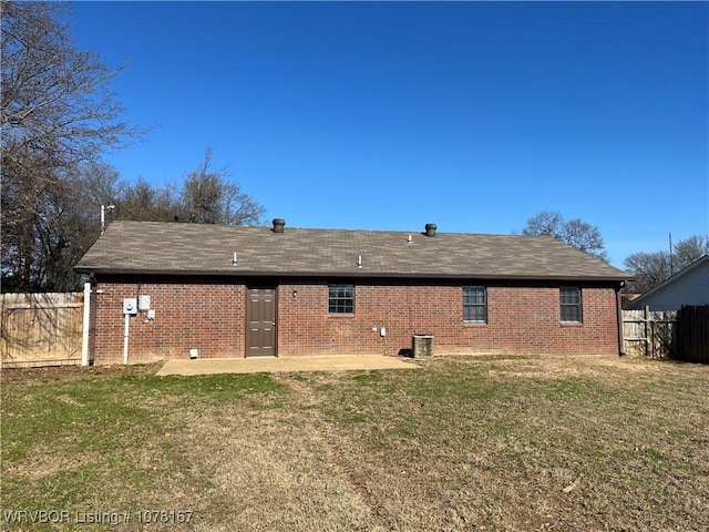 back of house with a patio area and a lawn