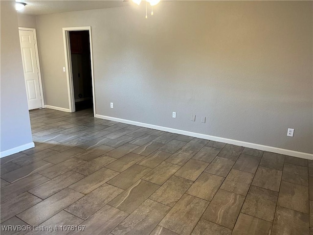 spare room with ceiling fan