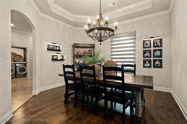 8404 Gatehouse Way, Fort Smith, AR 72916 - dining room with separate washer and dryer, arched walkways, dark wood-type flooring, a raised ceiling, and crown molding