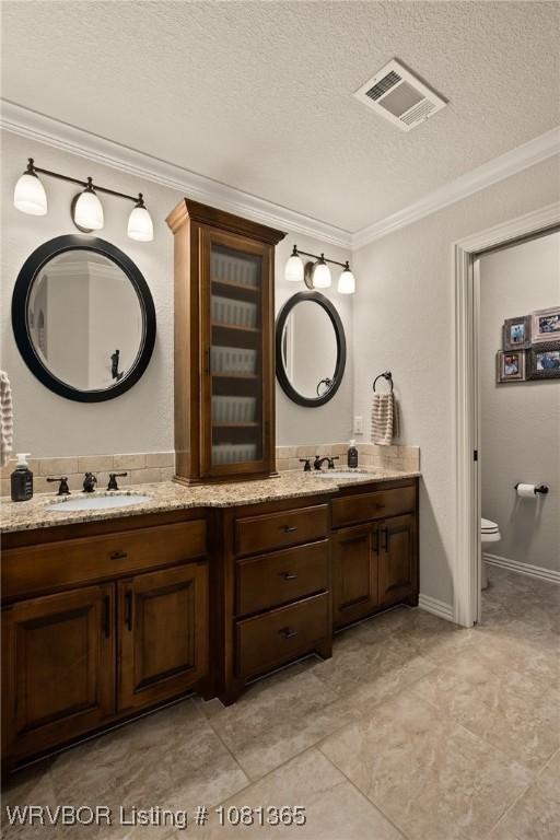 8404 Gatehouse Way, Fort Smith, AR 72916 - bathroom featuring double vanity, ornamental molding, toilet, and a textured ceiling