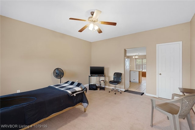 bedroom with light colored carpet, ceiling fan, and baseboards