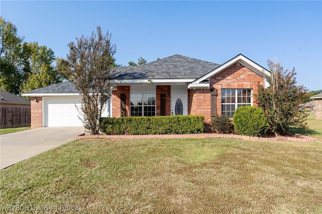 ranch-style home featuring a garage, a front yard, concrete driveway, and brick siding