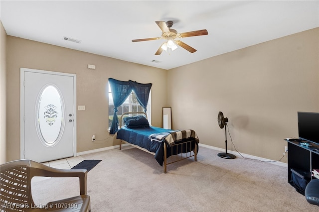 bedroom featuring light carpet, a ceiling fan, visible vents, and baseboards