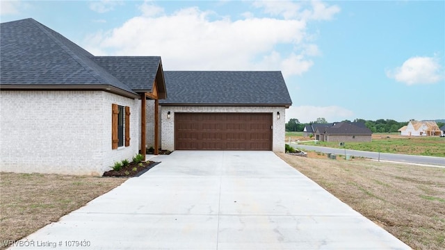 201 Twisted Oak Way, Greenwood, AR 72936 - view of front facade featuring a shingled roof, a garage, concrete driveway, brick siding, and a front yard