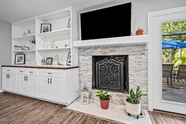 2509 Roxbury Ln, Fort Smith, AR 72908 - living area with dark wood finished floors and a fireplace with flush hearth