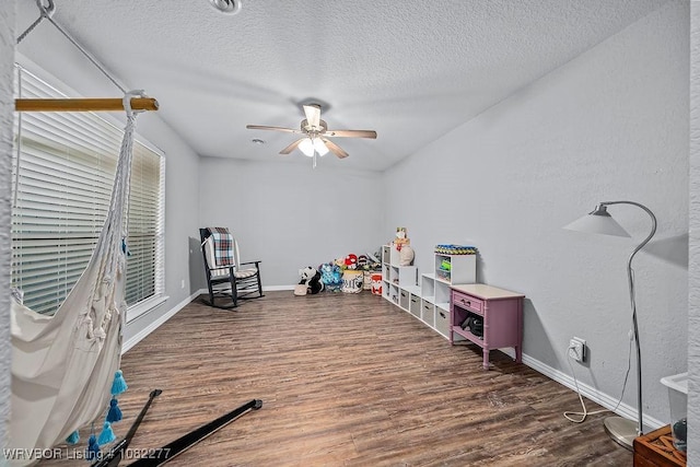 2509 Roxbury Ln, Fort Smith, AR 72908 - recreation room featuring ceiling fan, wood finished floors, and a textured ceiling