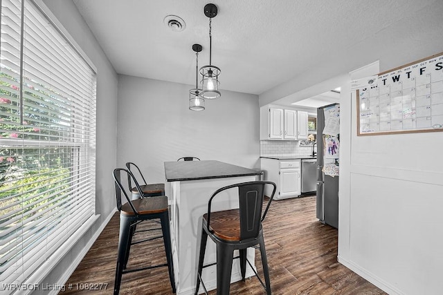 2509 Roxbury Ln, Fort Smith, AR 72908 - dining area with dark wood finished floors and a textured ceiling